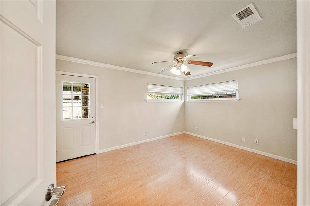 The primary bedroom, located at the back of the home, features engineered hardwoods with direct access to the backyard and covered patio.
