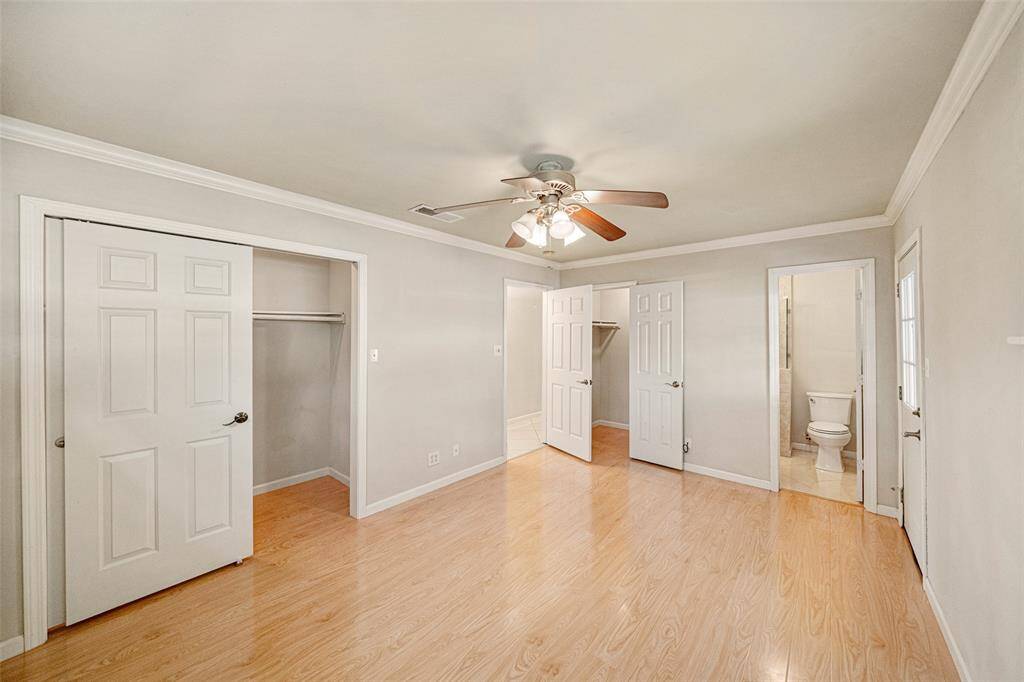 The primary bedroom boasts two walk-in closets and an en-suite bath providing ample storage and privacy.