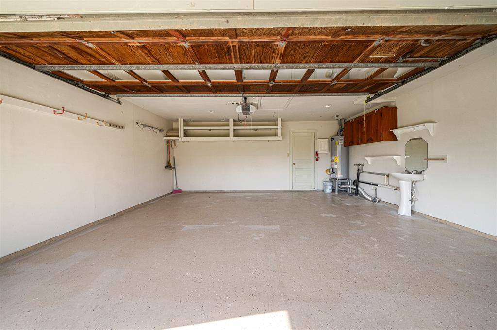 The garage has recently added epoxy flooring and storage. A utility sink next to the washer and dryer connections provides ease of access for those tough stains.