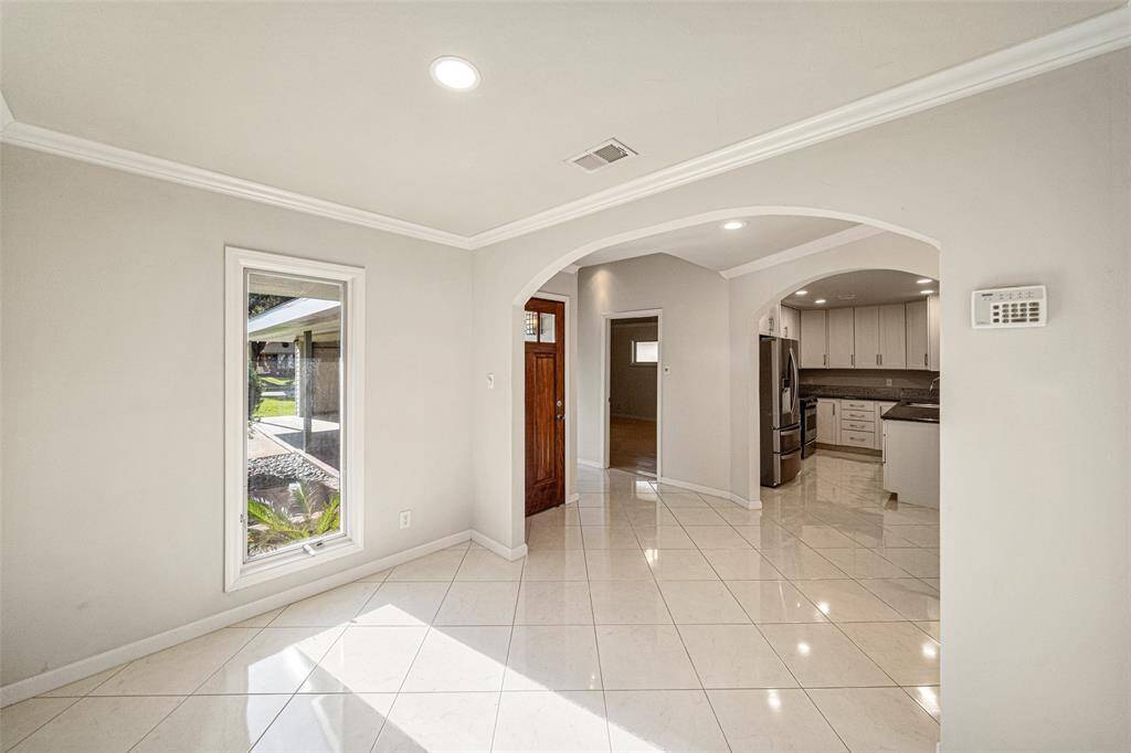 From this viewpoint you can see the dining room is just steps from the kitchen and just to the right of the front door is the added front bedroom.