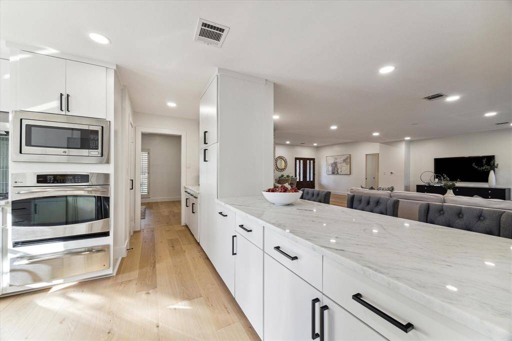 The kitchen opens to the living room beyond the breakfast bar.
