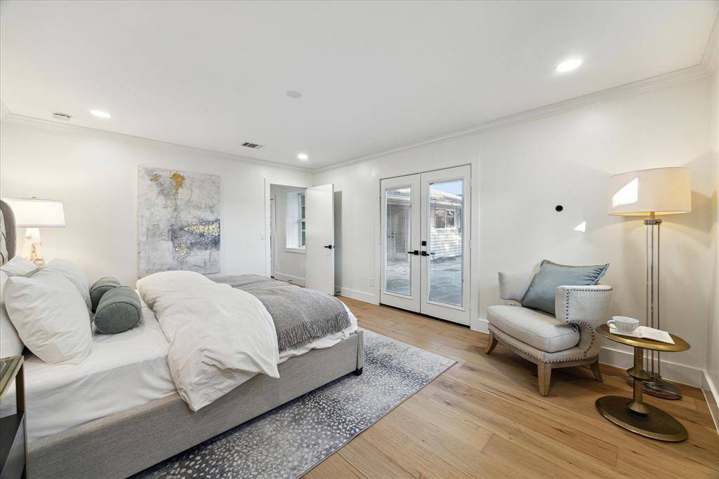 The large primary suite looks out on to the pool spa through a beautiful set of French doors.