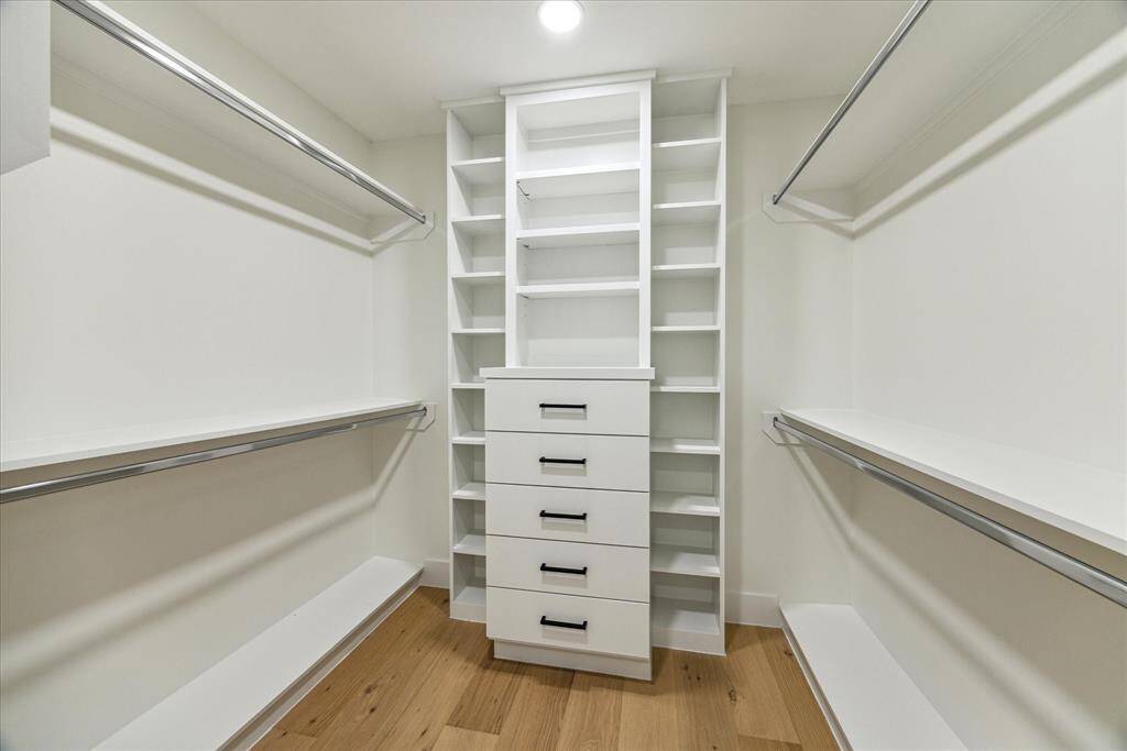 Plenty of hanging and storage space in the ensuite walk in closet.