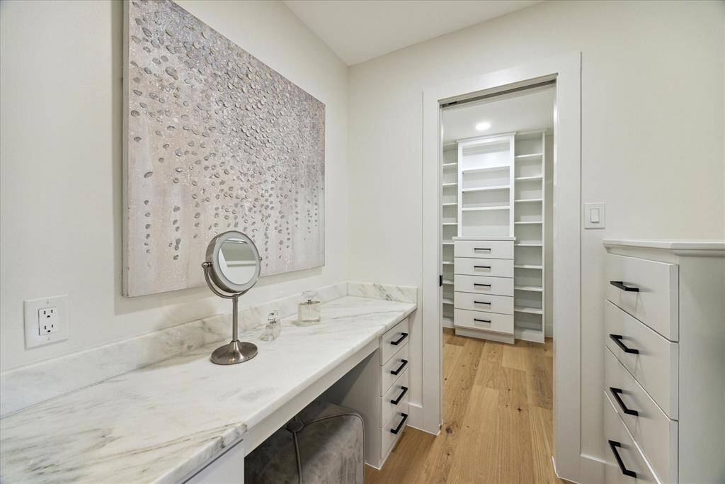Separate vanity between the ensuite bathroom and the walk-in closet.