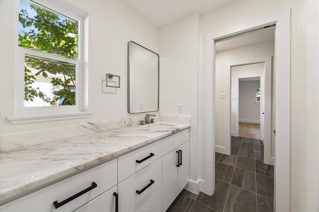 Jack and Jill bath with separate vanity areas.