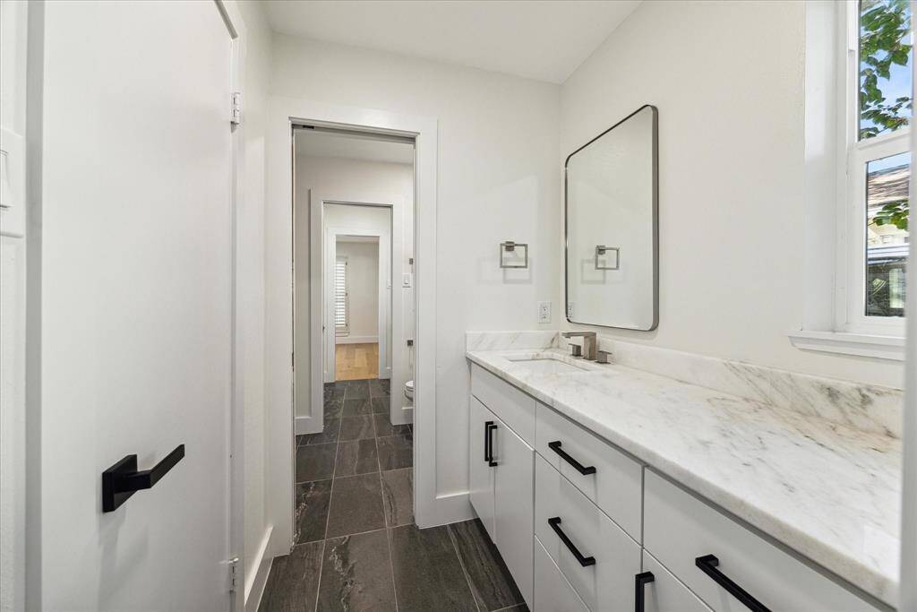 Jack and Jill bath with separate vanity areas.