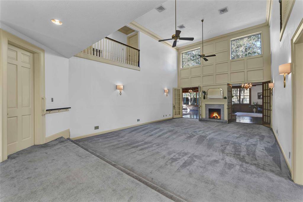 Formal ample living area has high ceilings and chimney