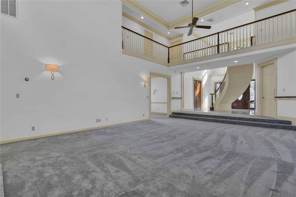 The room features neutral colors, wall sconces for lighting, and ceiling fans.
