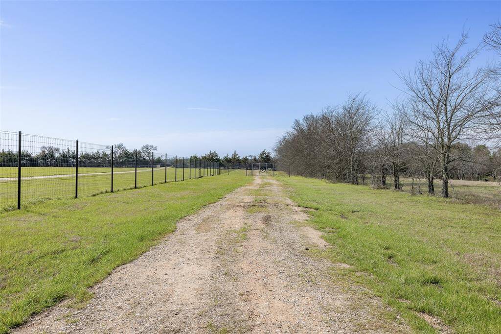 Looking out the gated entrance, heading towards County Road 208