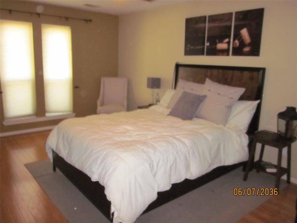 Primary bedroom with large lighted ceiling fan