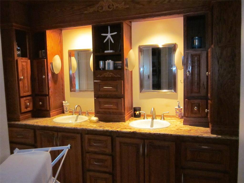 Master bath boasts plenty of storage, double sinks and granite counters