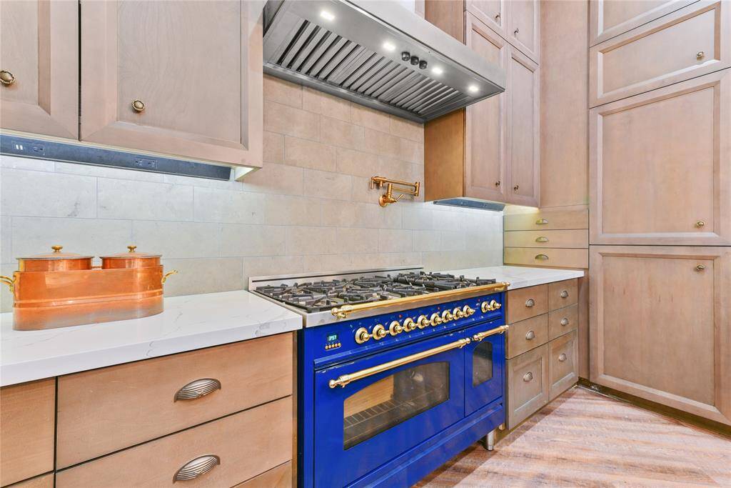 The custom kitchen was redesigned and renovated in '22.  It includes all new cabinetry, built-in refrigerator/freezer, two dishwashers, two chilled drink refrigerated drawers, deep stainless steel sink, and fabulous French built gas range with pot filler!
