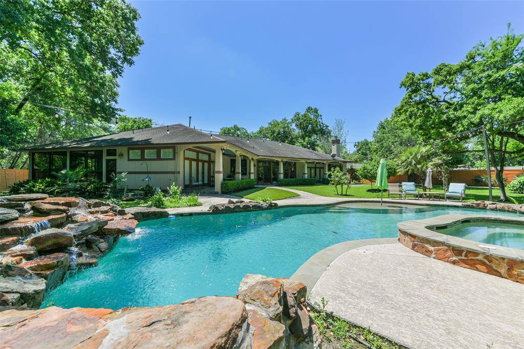 Along the rear of the main home is this charming slate porch area which runs almost literally across the entire rear of the home.  At one end is an outdoor fireplace to sit around on chillier evenings while you view out to the expansive grounds and lovely pool.