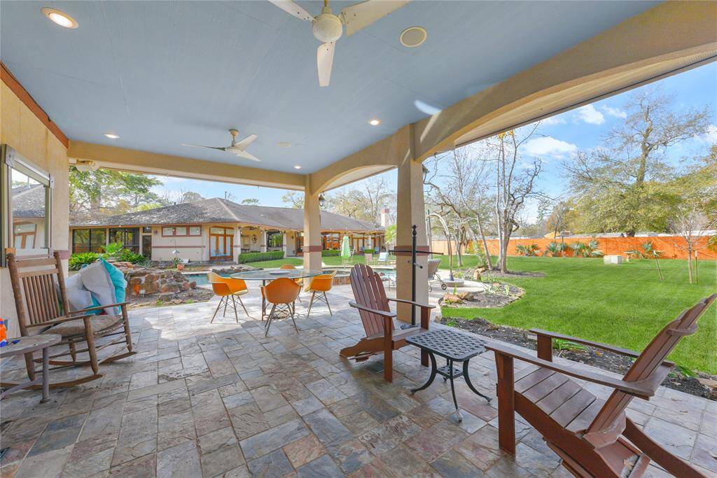 The pool house/guest house also has a sizable covered front patio to enjoy the immense yard area and pool.  Recessed lighting, mosquito control, ceiling fans, and speakers are just a few of the wonderful amenities to help you enjoy this area day or night!