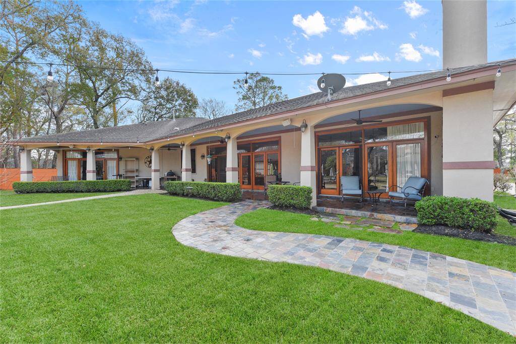 More of a side view of the main house showing the attached two car garage. Lots of parking for parties and two electric gates for easy ingress and egress. Both homes were custom built by their respective owners who are close friends.