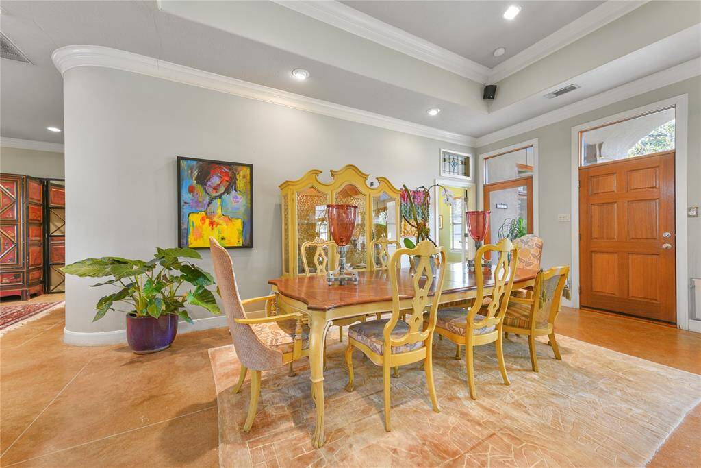 The living area flows right into the dining area with room easily for a table of 8 or even 10.  Note the beautiful crown moldings and curved walls.  The high ceilings make this home have an extra spacious feel.