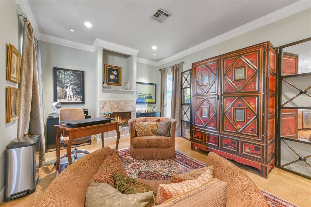 This room can have many functions.  It can be a den or family area or it can be a study also.  Note the fireplace with marble surround flanked by spaces for bookcases, large pieces of furniture, or art.