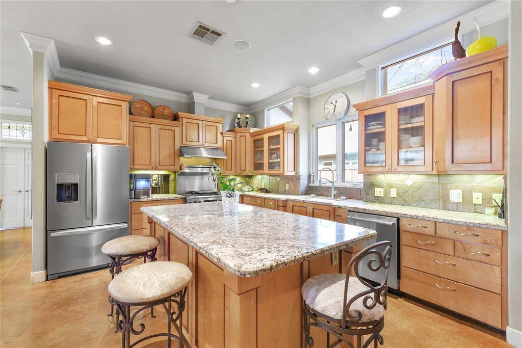 Lovely kitchen for the gourmet chef!  Large center granite topped island with plenty of counter work space and premium stainless steel appliances make this kitchen beautiful and functional.  There is a lot of storage space also.