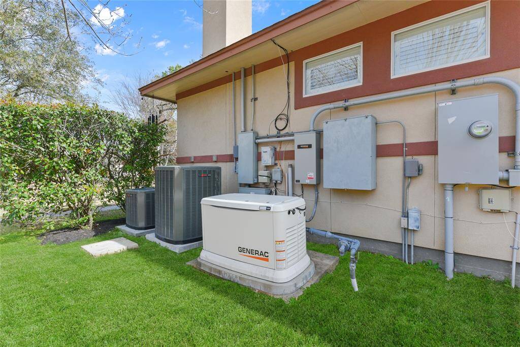 At the side yard of the main house, sits the home generator just in case of any power outages or "grid" emergencies.