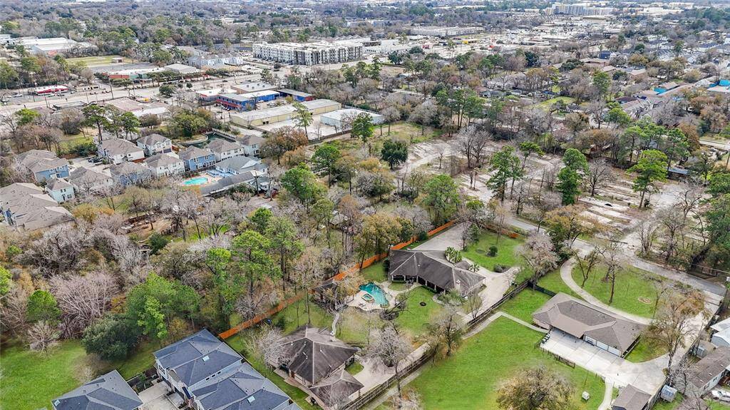 This drone shot shows the overview of the neighborhood area.  There are several "single family" homes on large lots along the street whilst there is also evidence of newer construction patio/town home gated developments.  There will be other new construction just across the street Here is an overview of the neighborhood area showing several large single family properties as well as evidence of newer construction patio / town home gated developments.  The area is renewing!