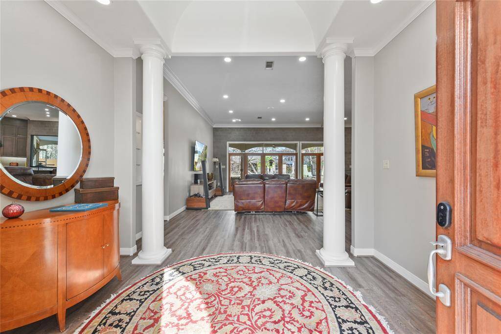 How is this for a dramatic entry foyer?!?  Enter into this lovely foyer anchored by the two large columns as well as the lighted barrel style ceiling treatment.  Great wall space for art or special pieces of furniture!