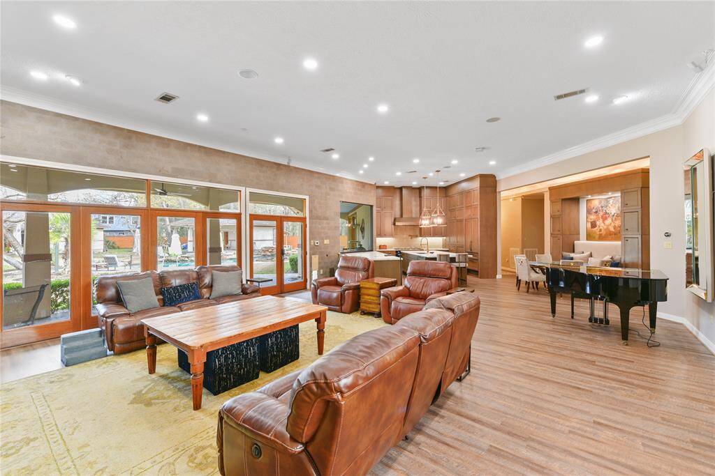 Here literally entering into the foyer and looking towards the main living area and out to the rear patio.  Just left past the columns enters into the Primary Suite which is separate from all of the other bedroom areas for ultimate privacy.