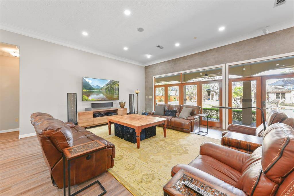 Another view of this great room style living area with LED recessed lighting and speakers in the ceiling.