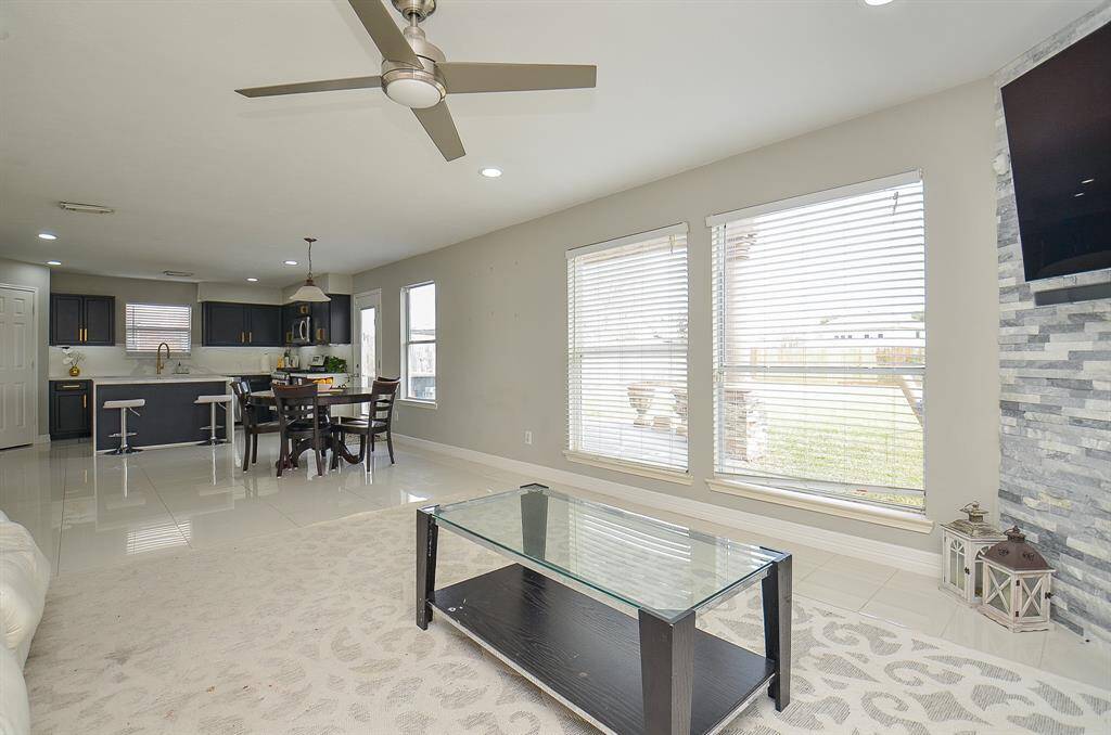 The room is bathed in natural light streaming in from the large windows.