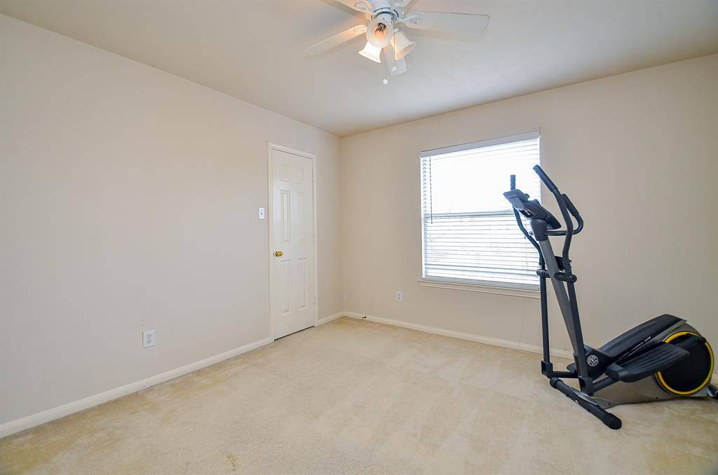 The large window, adorned with white blinds, allows for ample sunlight to flood the room, making your exercise sessions feel invigorating.