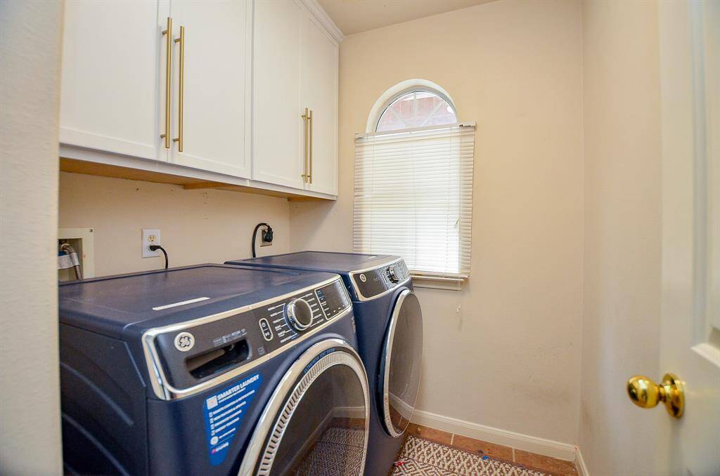 Your laundry room with cabinets for storage.