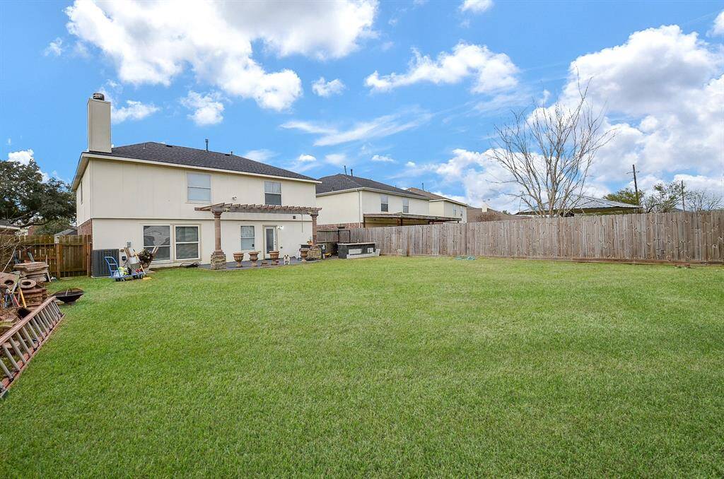 A spacious, well-maintained lawn invites you to enjoy outdoor activities or simply bask in the sunshine.
