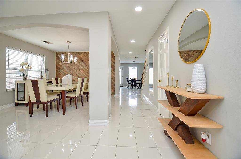 Step inside to discover an open floor plan flooded with natural light from large windows, offering a warm and inviting atmosphere.