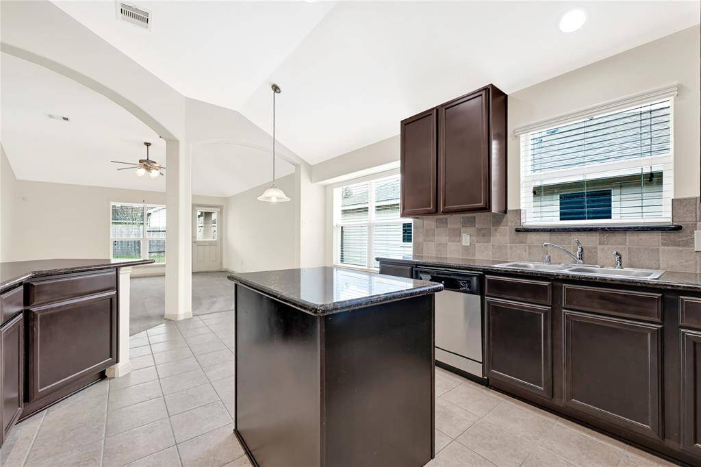 There is a generous amount of granite counter space in this kitchen to include a center island and breakfast counter space for stools as additional seating. A breakfast table will have ample room with a nice drop light fixture already in place.