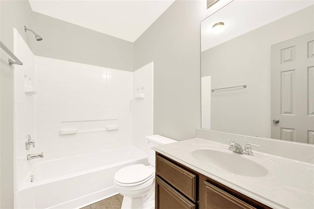 The secondary bathroom has a combination shower/tub and is conveniently located outside the two additional bedrooms.