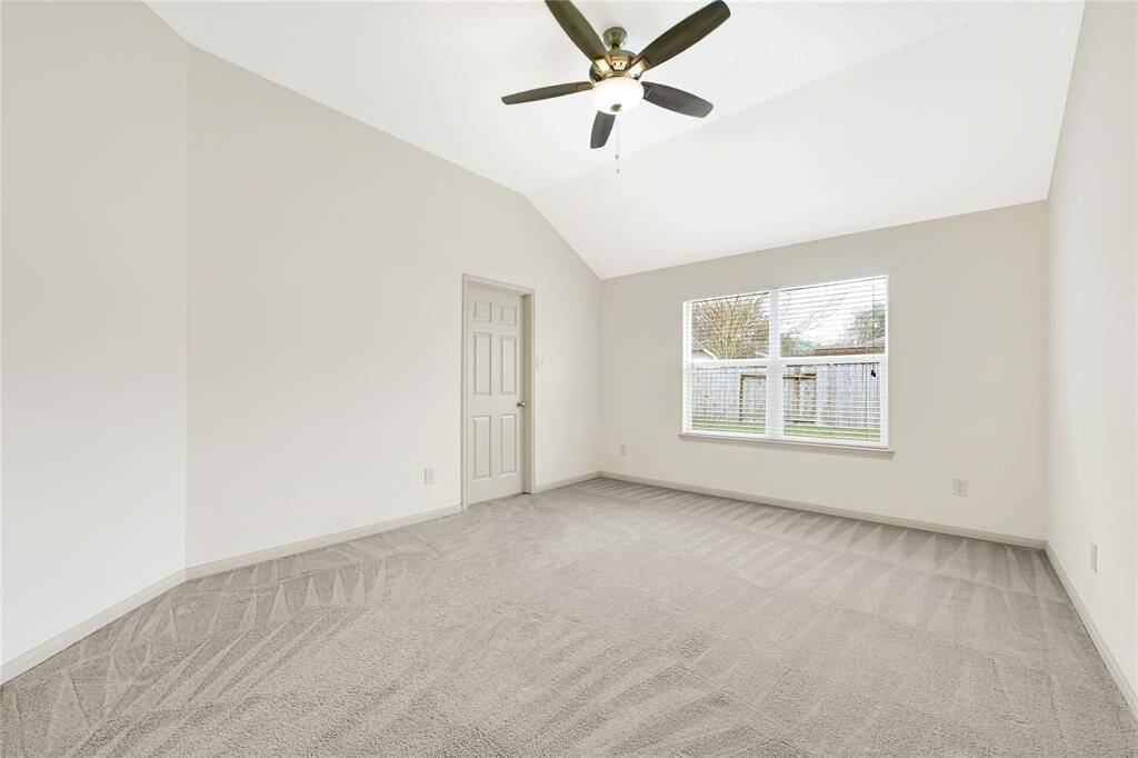 The large primary bedroom is located in the back of the home for privacy and peace. The sloped ceiling is a nice touch.