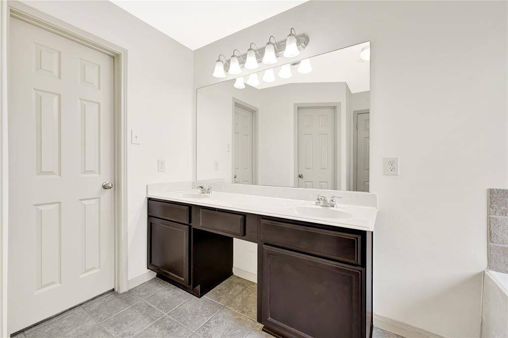 The primary bathroom also has double sinks and a vanity space with an enclosed water closet for extra privacy.