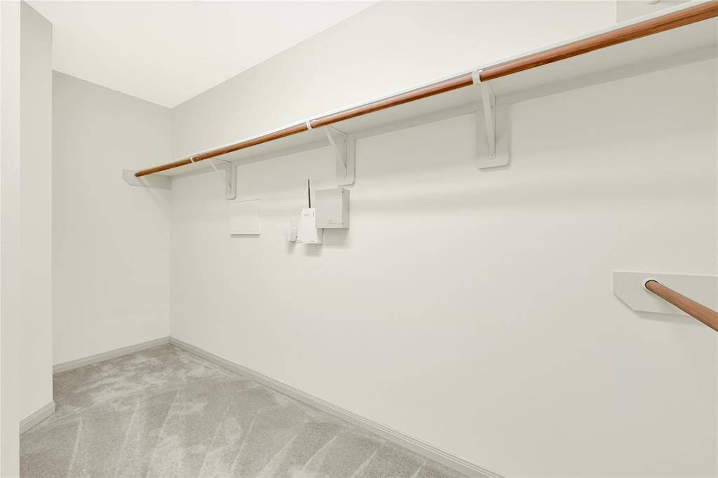 The primary walk-in closet provides plenty of space for clothes and storage.
