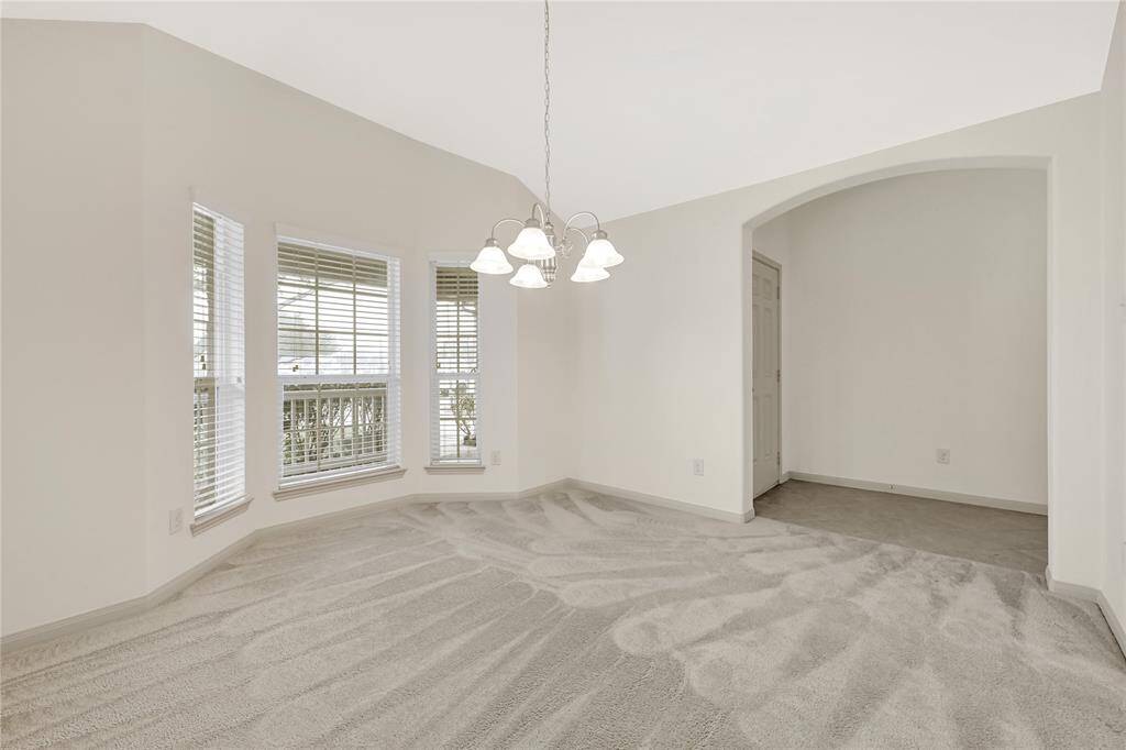 The formal dining space or flex room is generously sized. The large windows provide abundant natural light.
