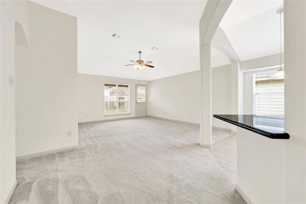 What a great open space with such nice open archways to divide the living space from the kitchen and large foyer.