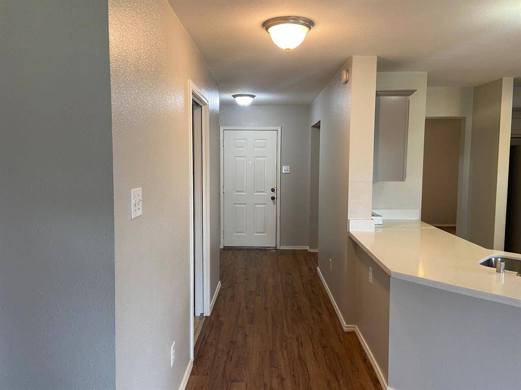 Welcome guests with this inviting foyer, featuring elegant flooring and soft, ambient lighting.