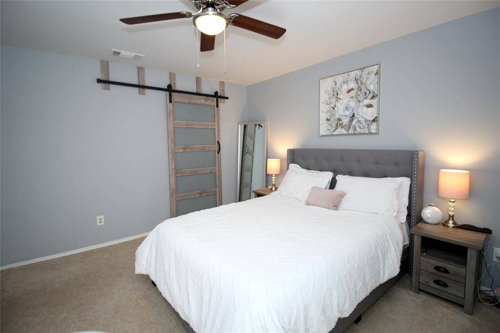 Another view of master bedroom with modern barn door for master bath