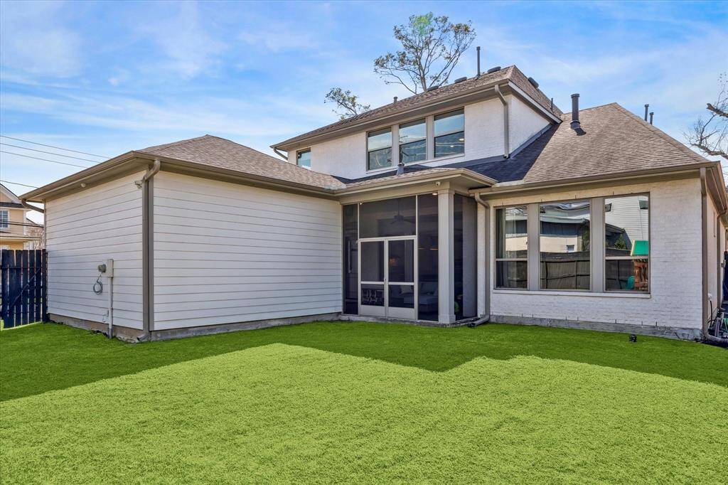Screened-in patio offers year-round comfort while providing direct access to the detached garage. Thoughtful design ensures a smooth transition between indoor and outdoor spaces, with large windows maximizing natural light and backyard views. The spacious yard allows for versatile outdoor living and entertaining.