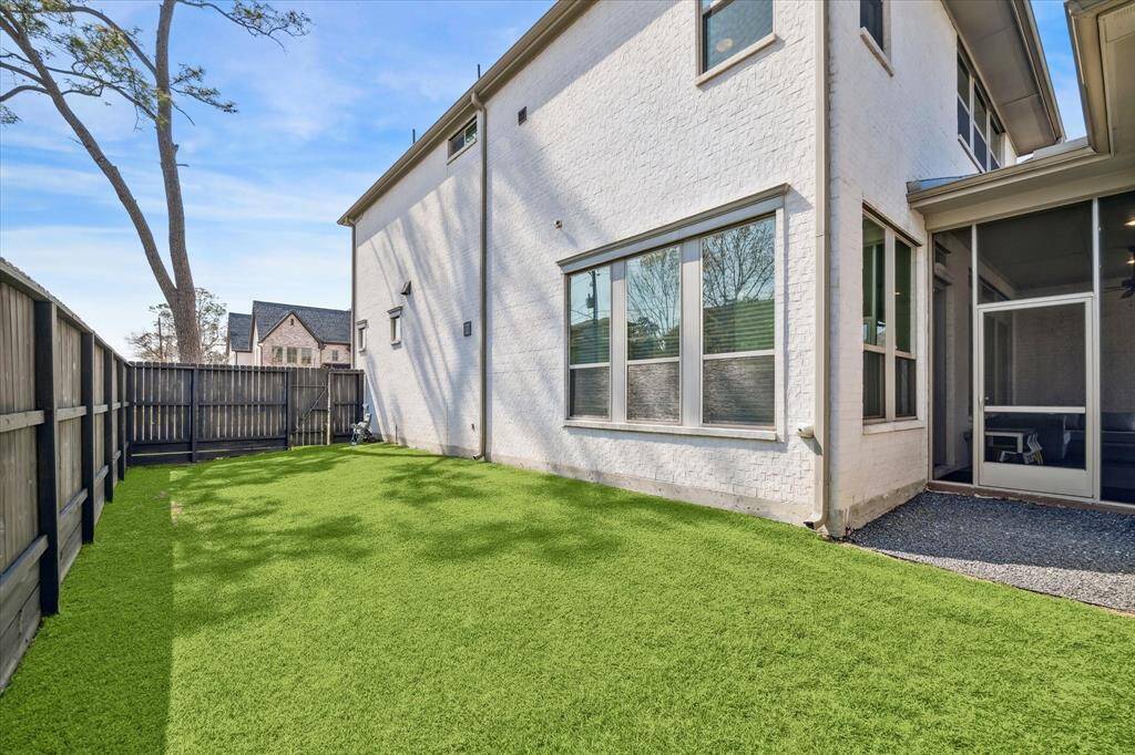 Well-maintained side yard provides extra outdoor space, perfect for pets, gardening, or additional play areas. The fenced perimeter offers security and a sense of enclosure.