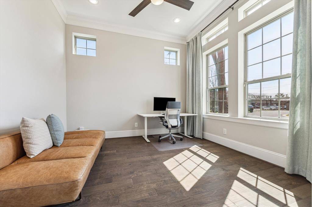 Flooded with natural light, this private home office offers a serene and productive space with oversized windows and elevated ceilings. A perfect blend of function and style, this room provides a quiet retreat while maintaining a connection to the home’s elegant design.