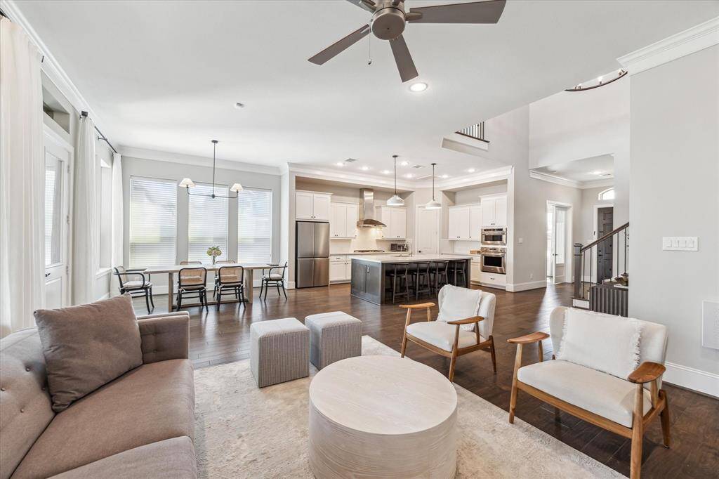 A seamless open-concept layout effortlessly connects the living, dining, and kitchen areas, creating a spacious and functional design. Large windows invite natural light, while the chef’s kitchen with an oversized island serves as the heart of the home, perfect for entertaining or casual gatherings.