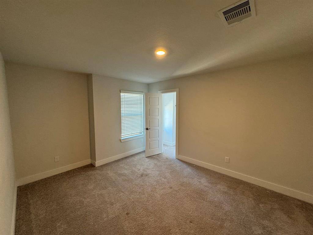 Bedroom 3 walk in closet with a window