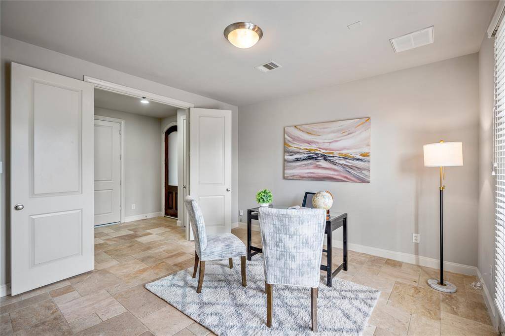 Another view of this first-floor bedroom with neutral tile floors.