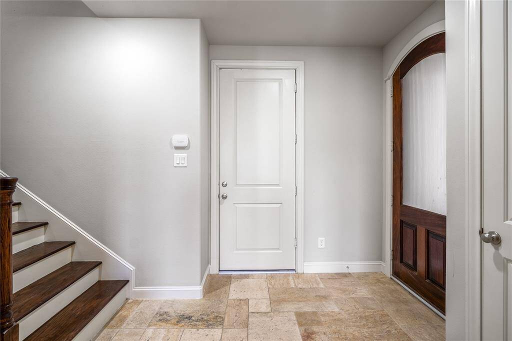 Door straight ahead takes you into the garage. Notice no carpet on the stairs in this home. Let's take you upstairs to the second floor.