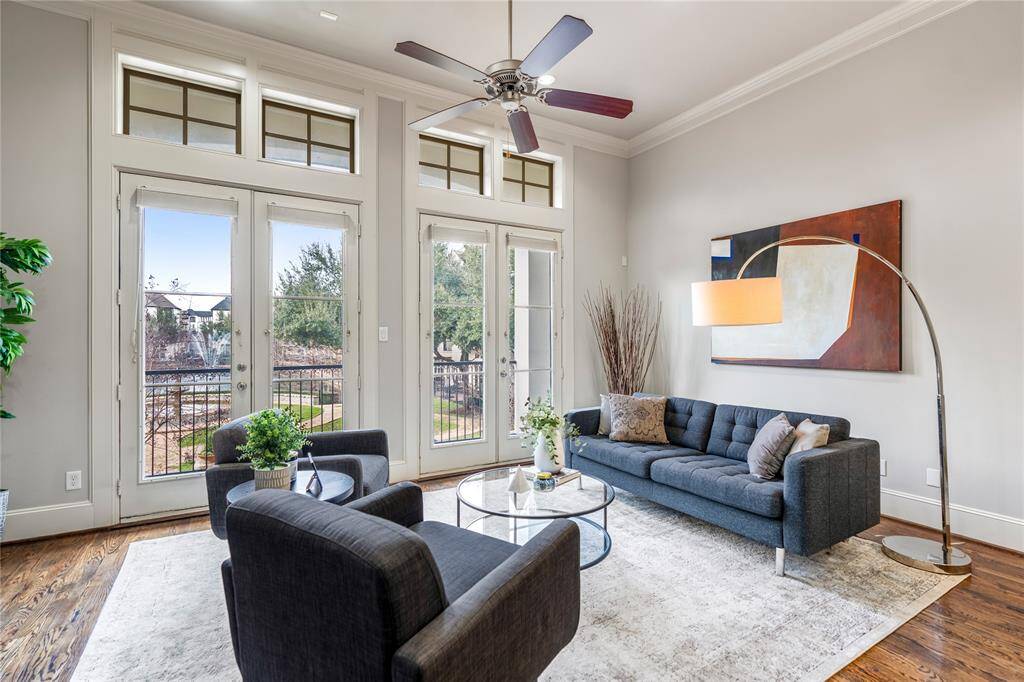 Two sets of double French doors overlook the beautiful community lake with a water feature. Plenty of natural light in this home.