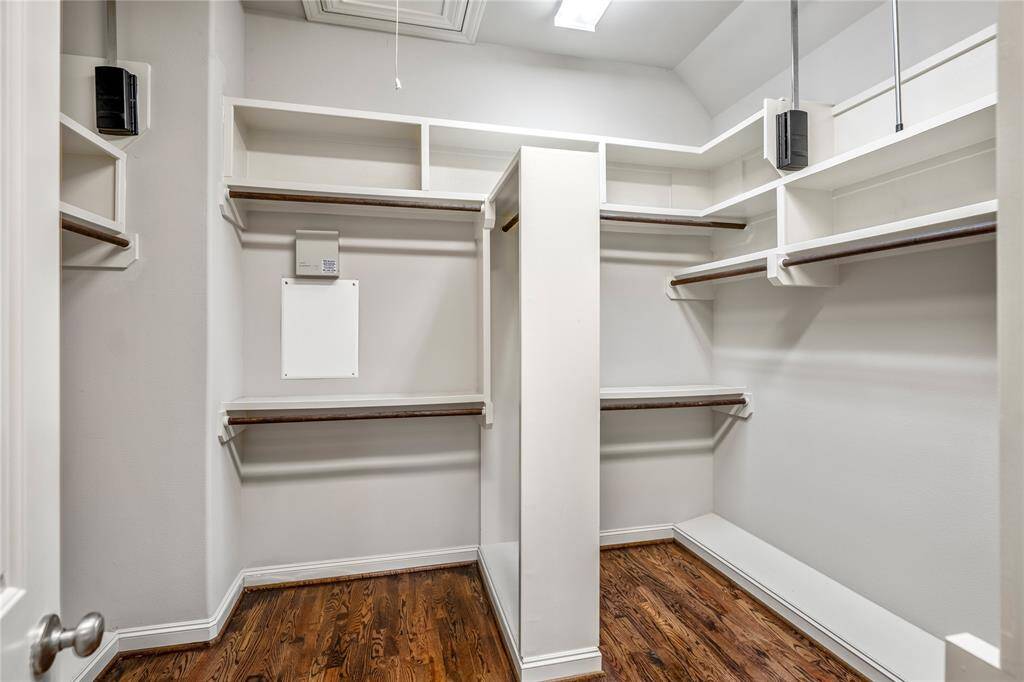 Large, walk-in closet with ample storage on top for seasonal storage.